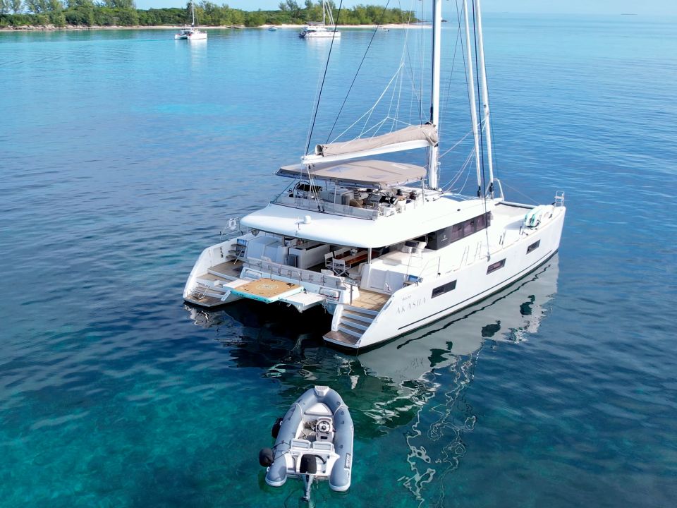 Sailing catamaran anchored in clear blue water