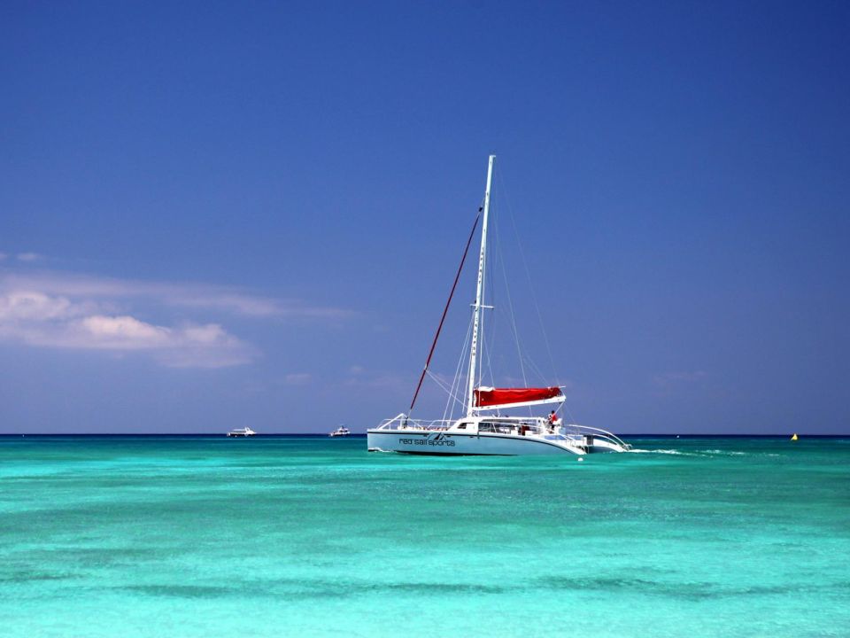 Sailing catamaran on calm turquoise water