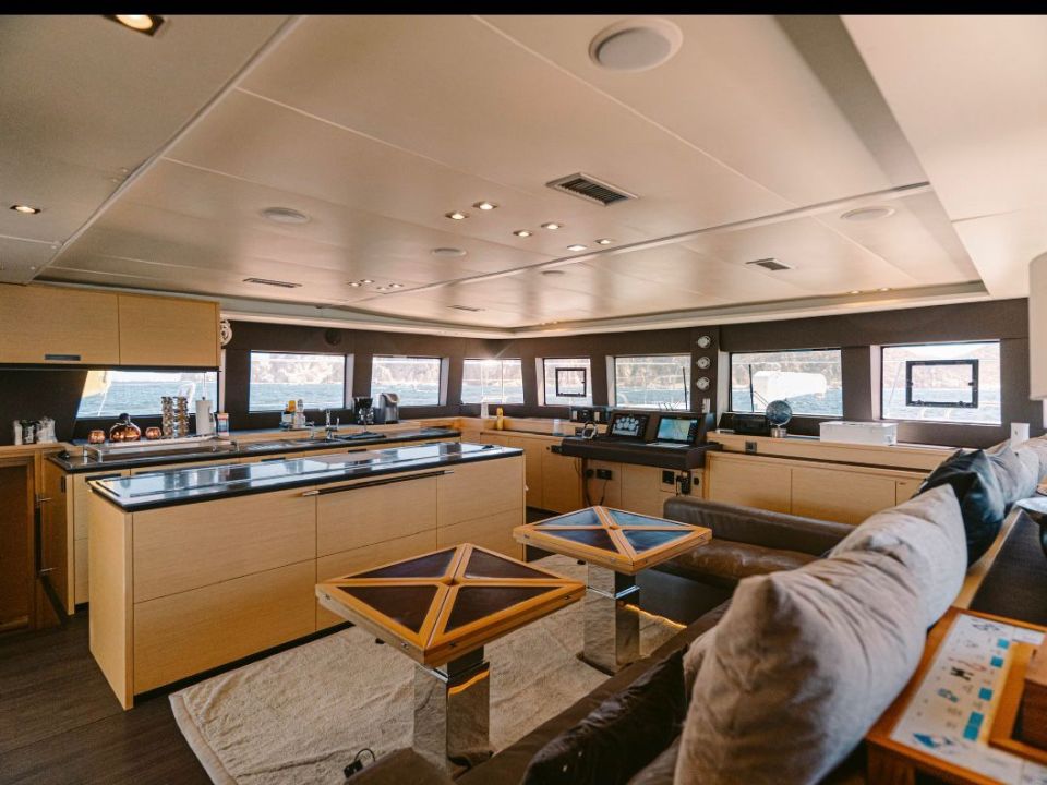 Spacious catamaran salon with galley counters and lounge seating