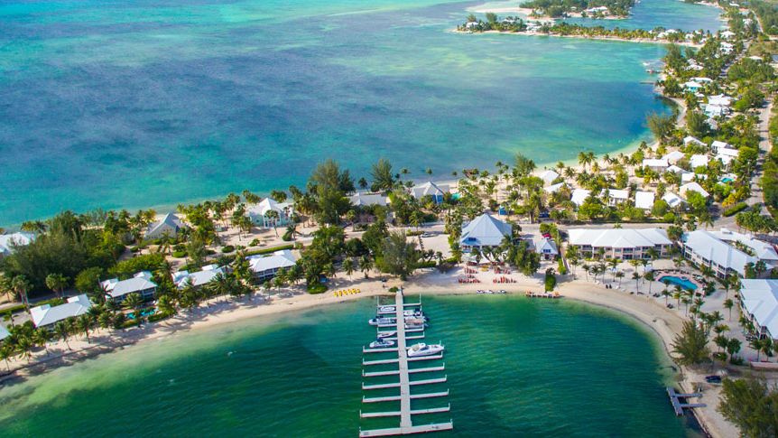 Aerial view of the Cayman Kai shoreline and a marina dock on the North Sound side of Grand Cayman