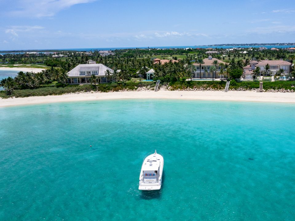 Motor yacht anchored in clear turquoise shallows