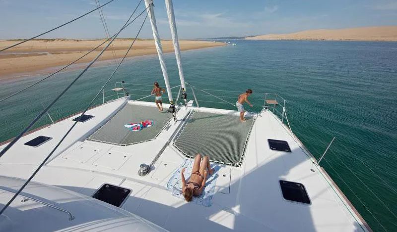 Guests on the forward trampolines of the 62' Lagoon