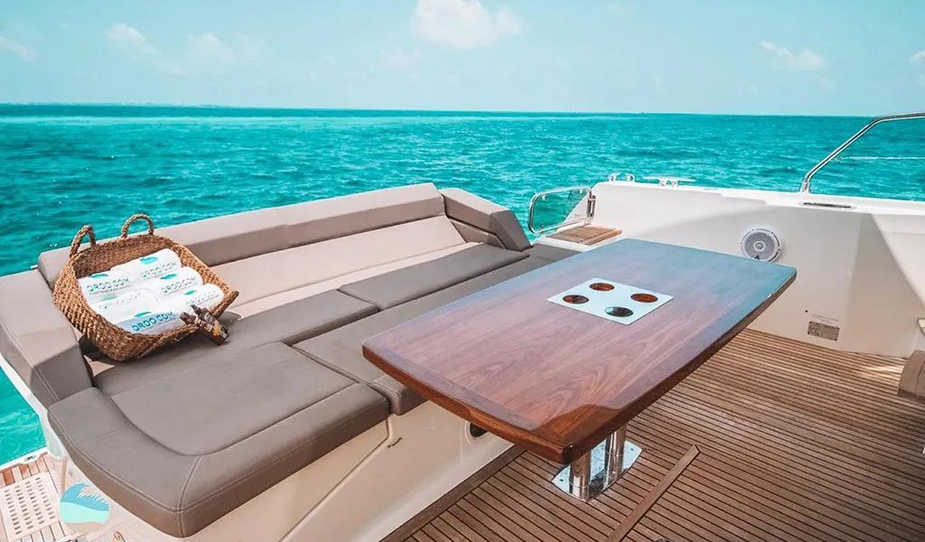 Cockpit of the 55' Princess with a teak table and cushioned bench