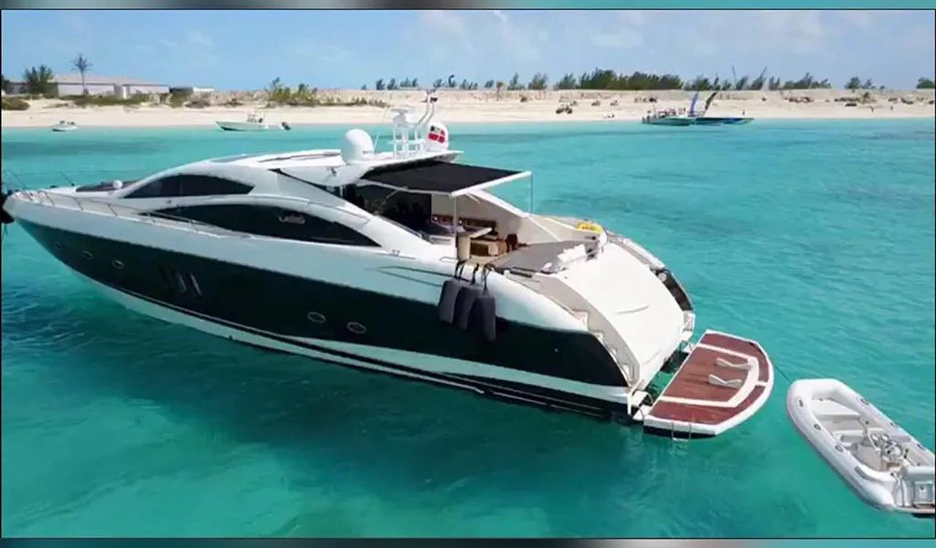 82' Sunseeker anchored off a beach with its tender alongside